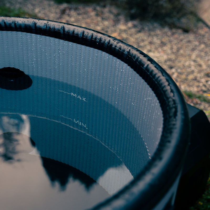 Detail photo of the LUMI Pod Pro ice barrel, filled with ice cold water in an outdoor setting