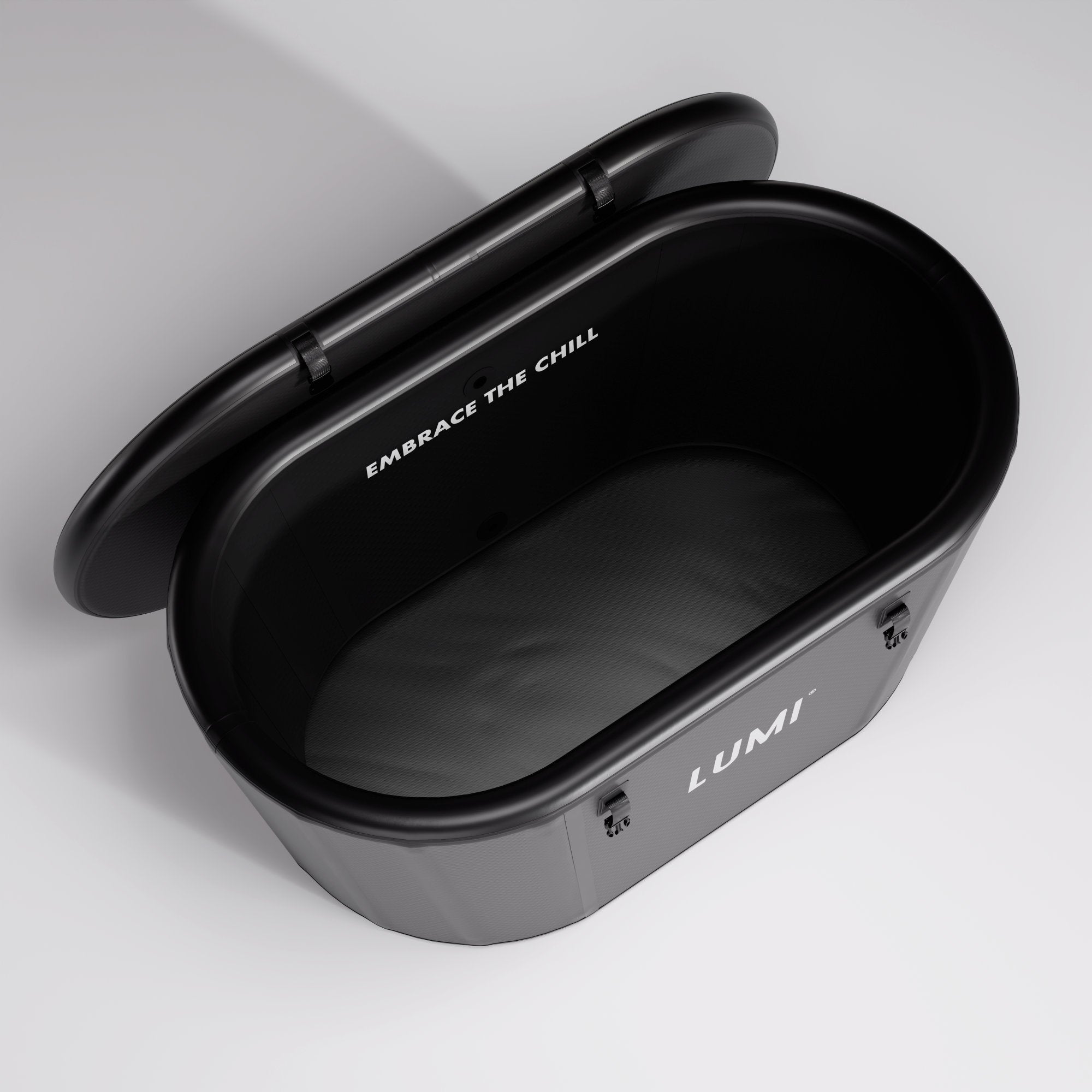 Open LUMI Recovery Duo PRO Ice Bath in black with lid open showing smooth interior and "Embrace The Chill" text inside