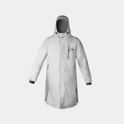 PRO DUO Changing Robe in Grey features a hooded waterproof design with fleece lining, zippered pockets, and adjustable cuffs. Long-length robe shown against white background, displaying its modern Nordic-inspired outerwear styling and functional details.