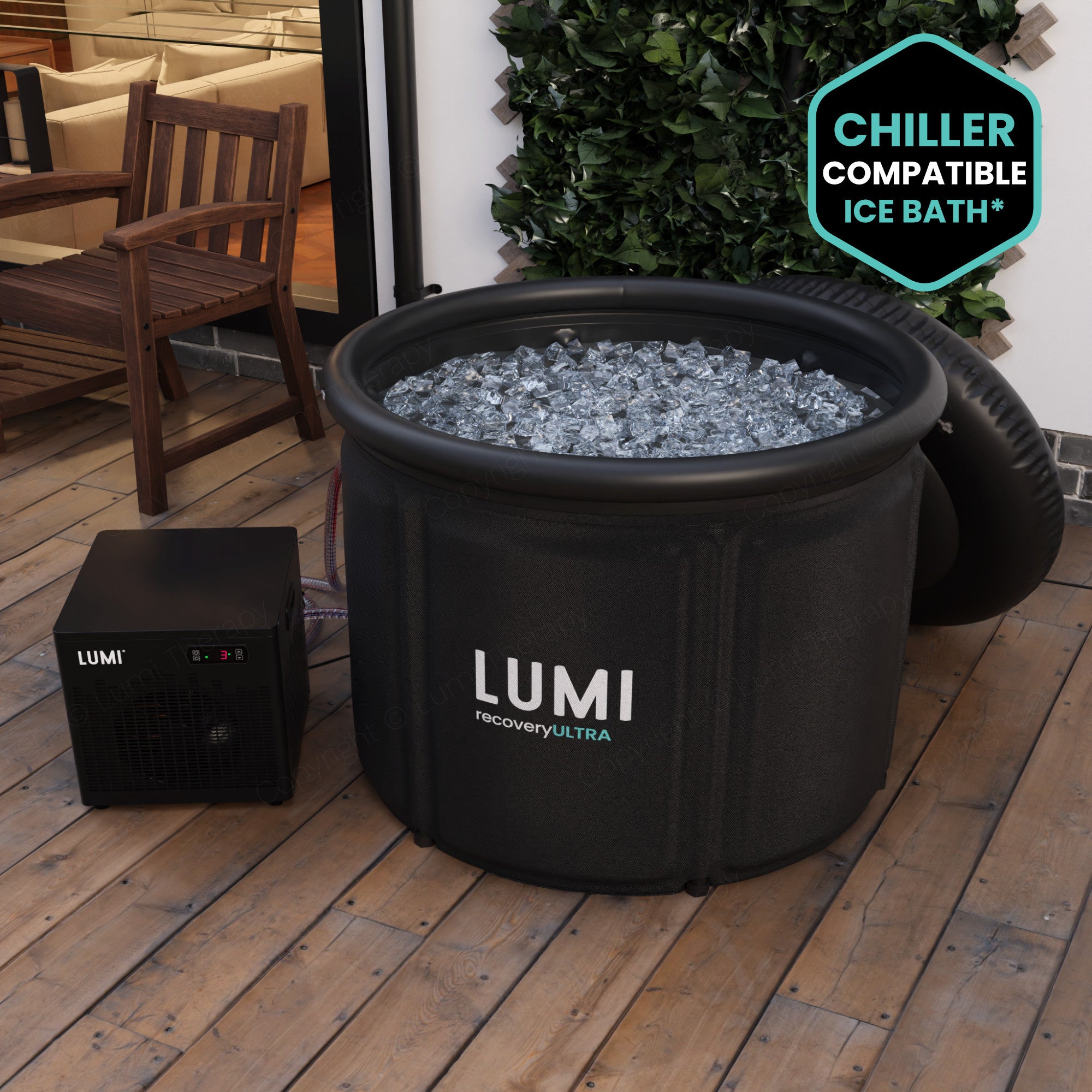 A LUMI Recovery Pod Ultra Ice Bath Black with LUMI Cube Chiller Bath on outside decking