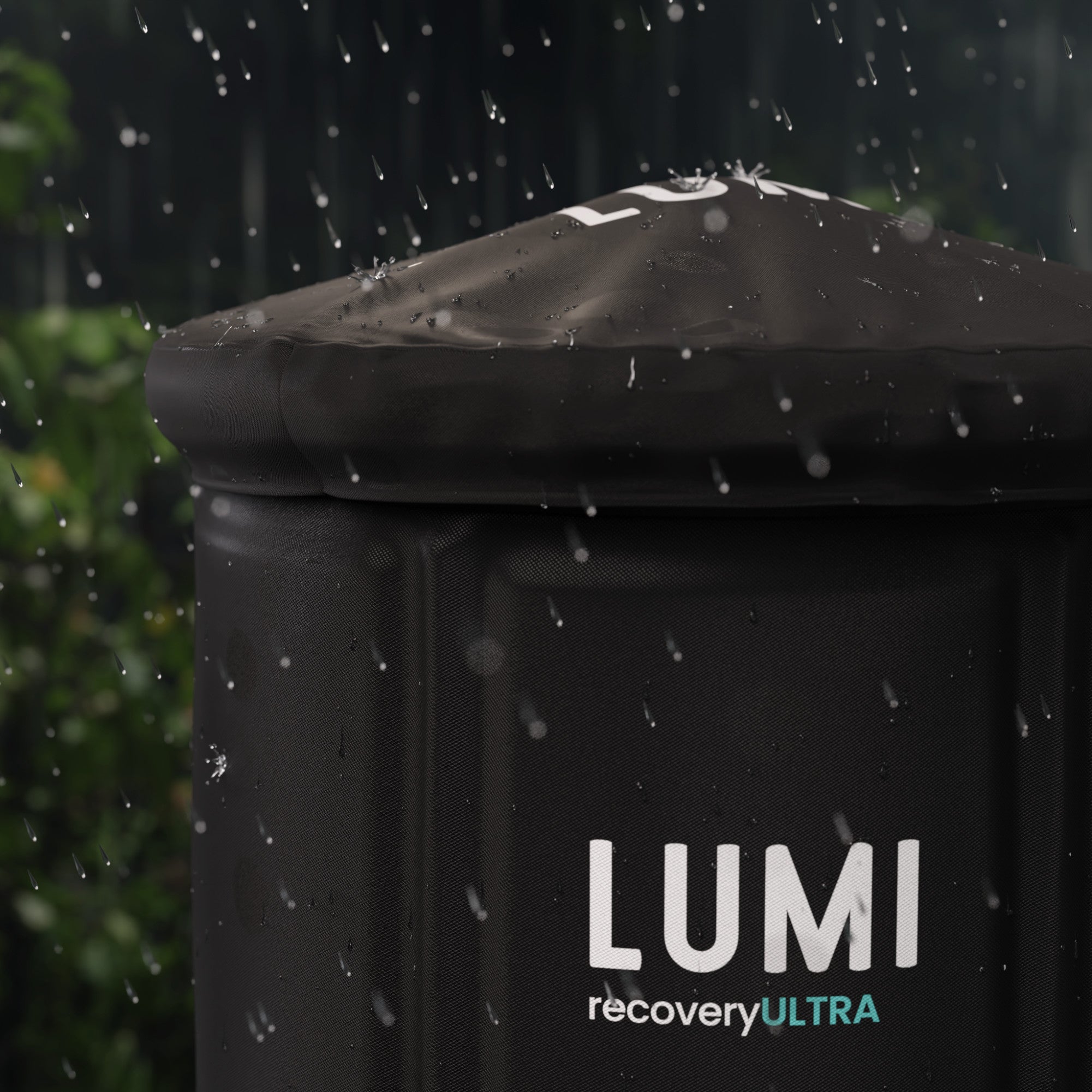 LUMI Recovery Pod Ultra Ice Bath Black All Weather Cover outside with rain coming down on it