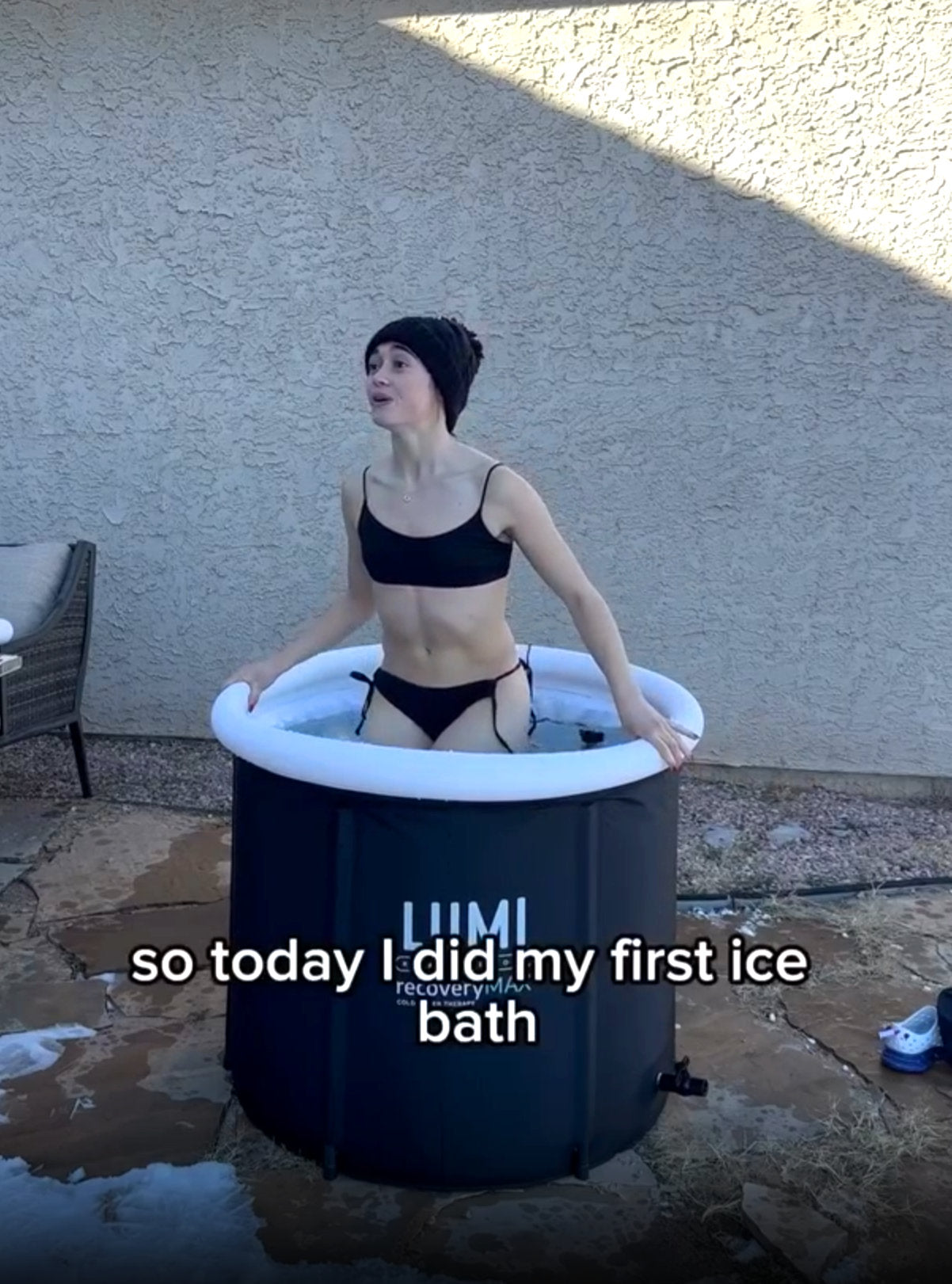 A woman getting into a LUMI Recovery Pod ICe Bath