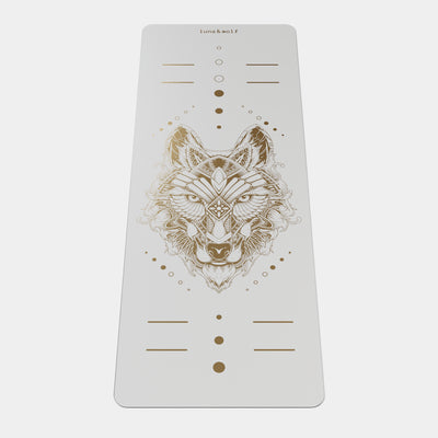 Eco Wolf Yoga Mat - Gold Edition featuring a white mat with intricate geometric wolf head design in metallic gold, alignment markers, and Luna & Wolf branding. Premium non-slip exercise mat with artistic positioning dots and lines.