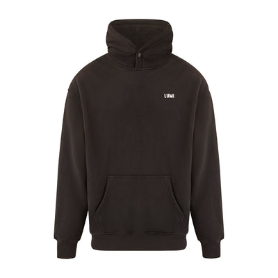 Unisex LCC Oversized Hoodie Black featuring a minimalist design with adjustable hood, kangaroo pocket, and small LUMI logo on chest. Premium black cotton-polyester blend hoodie with ribbed cuffs and popper button detail, showcasing comfortable oversized fit and LUMI Cold Club graphic on back.