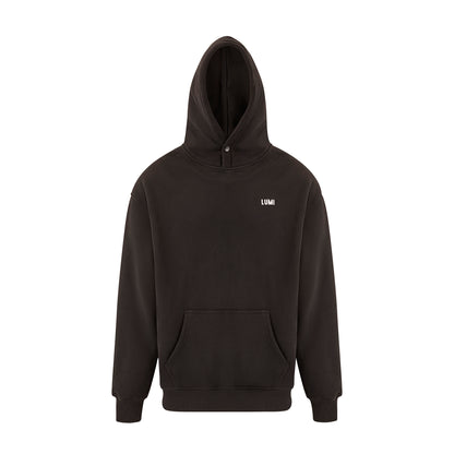 Unisex LCC Oversized Hoodie Black featuring a minimalist design with front kangaroo pocket, adjustable hood, ribbed cuffs, and small white LUMI logo on chest. Back displays LUMI Cold Club graphic. Premium black cotton-polyester blend fabric showcases modern streetwear aesthetic.