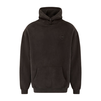 Unisex LUX Oversized Hoodie Black Wash featuring a relaxed fit design with adjustable hood, front kangaroo pocket, and subtle rubber logo detail. Heavyweight cotton blend hoodie in black wash finish with ribbed cuffs and popper button closure.