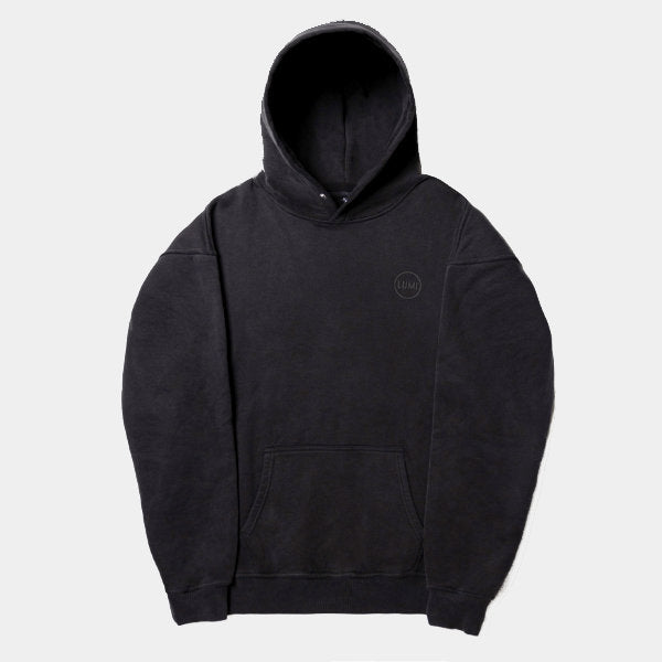 Unisex LUX Oversized Hoodie Black Wash featuring a minimalist design with raised rubber Lumi logo, adjustable hood with popper button, front kangaroo pocket, and ribbed cuffs, shown in a washed black color on a white background