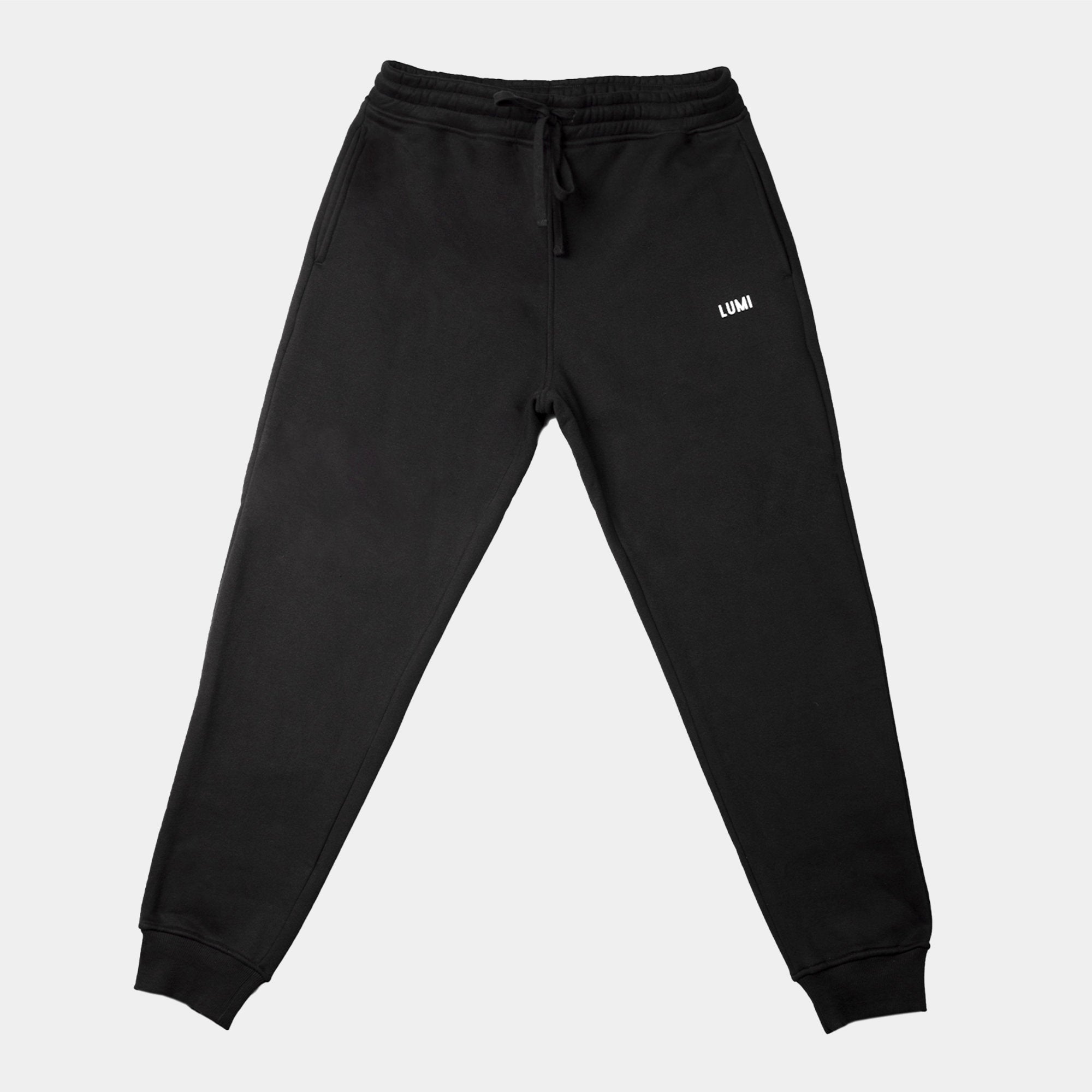 Men's LCC Sweatpants Black - Heavyweight cotton-polyester blend joggers with elastic waistband, cuffed ankles, and white LUMI logo. Relaxed-fit design shown in solid black color against white background, featuring drawstring closure and comfortable athletic styling.