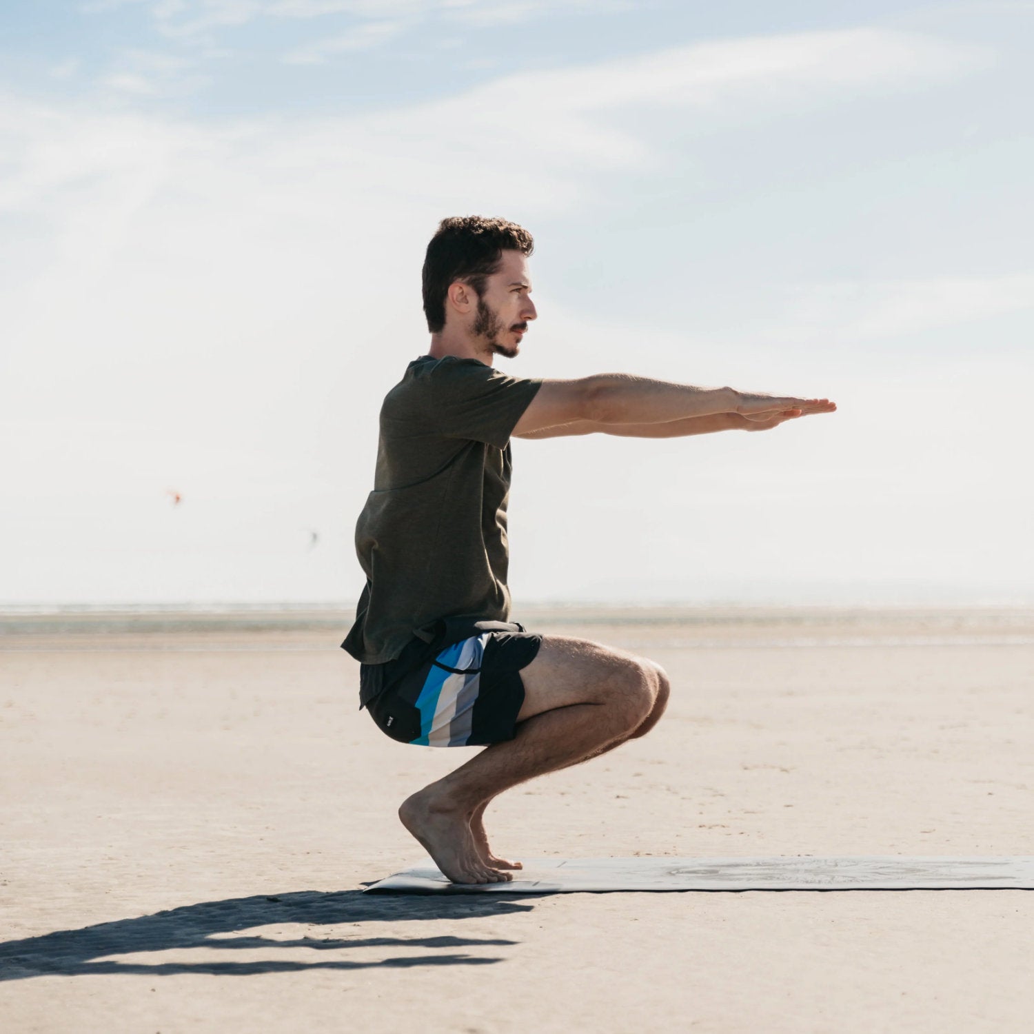 Lumi Therapy - A man doing squats on the beach