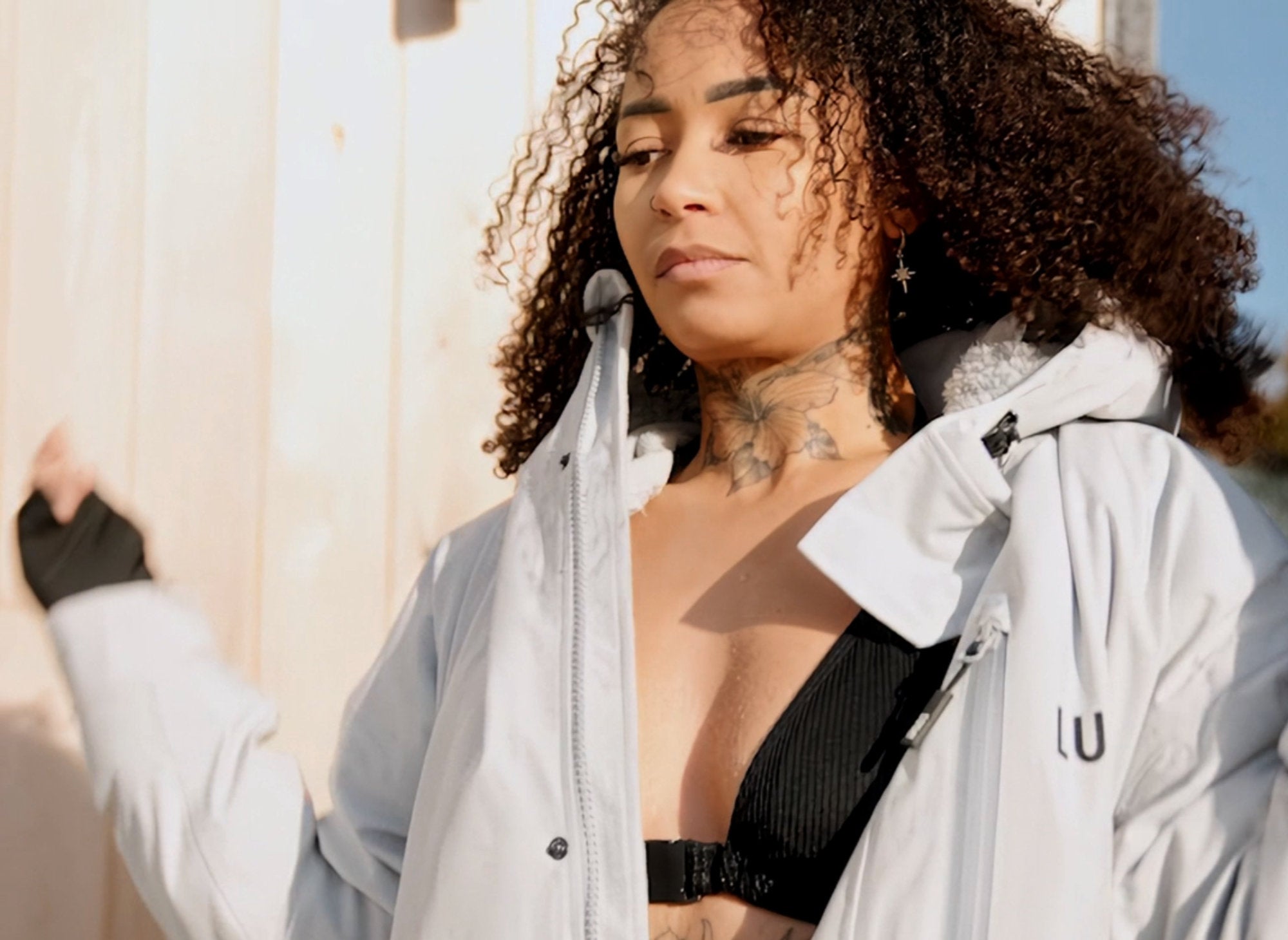 Woman wearing the light gray LUMI dry changing robe jacket