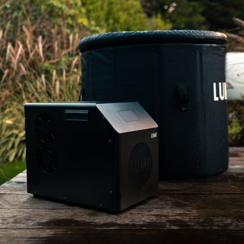 Photo of the LUMI Mini Chiller 2 next to the LUMI Pod MAX Ultra ice bath, in an outdoor setting.
