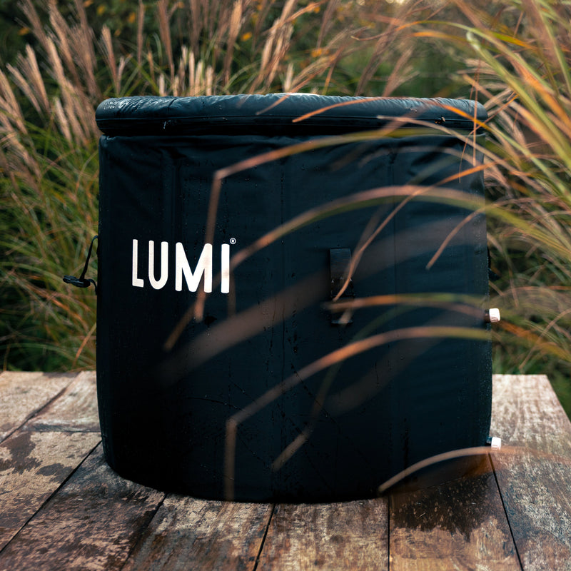 Photo of the LUMI Pod 2 ice bath on a wooden patio, in an outdoor setting.