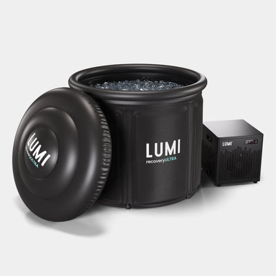 LUMI Recovery Ultra and Cube Chiller set featuring a large black portable ice bath filled with ice water, alongside a compact black cooling unit. Professional-grade cold therapy system with removable lid and integrated cooling technology.