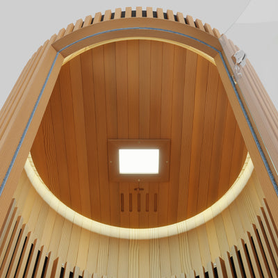 LUMI Infrared Sauna PRO interior ceiling view showing elegant curved Hemlock wood paneling, built-in LED light panel, and premium barrel-style construction with modern Nordic design elements emphasizing warmth and craftsmanship